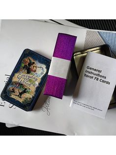 the contents of a purple and white card case