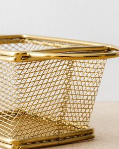 a gold basket sitting on top of a table