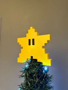 a yellow pacman head on top of a christmas tree