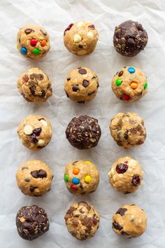 chocolate chip cookies with m & m and m's in the middle on white paper