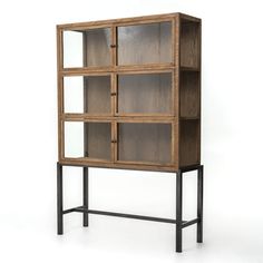 an open bookcase with four glass doors and metal legs, against a white background