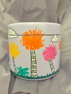 this is a hand painted bowl with palm trees and clouds in the sky on it