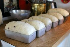 several loafs of bread sitting on top of a wooden counter