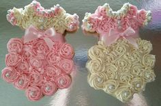 two cupcakes decorated with pink and white icing