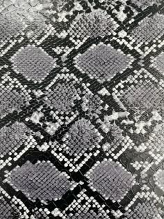 a black and white snake skin pattern on the surface of an animal print fabric,