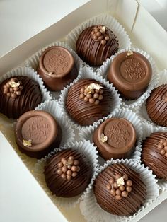 chocolates are arranged in a white box on a table