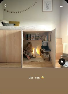 there is a child reading in the small room with her bed and bookshelf