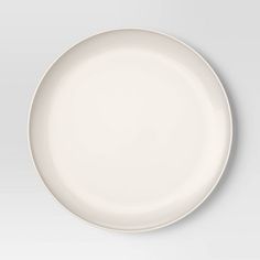 an empty white plate on a gray background