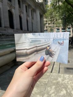 a person holding up a piece of paper with an image of a man riding a skateboard