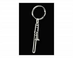 a metal keychain with a knife on it's side and a black background