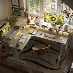 an image of a desk with two computers on it and flowers in the window sill