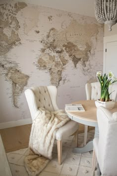 a dining room with a map on the wall