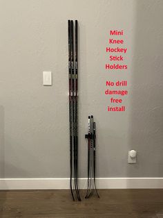 there are two skis on the wall and one is hanging up against the wall