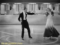 a man and woman are dancing in an old fashion dance ring with their arms outstretched