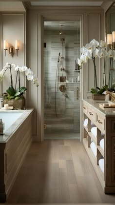 a large bathroom with a walk in shower next to a bathtub and two sinks