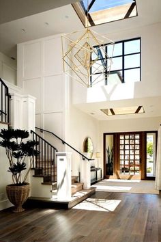 an open floor plan with wood floors and skylights above the stairs, is shown