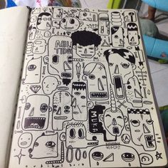 an open notebook with black and white drawings on it