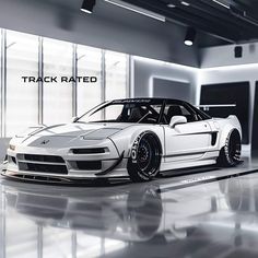 a white sports car is parked in an empty garage with the words track rated on it