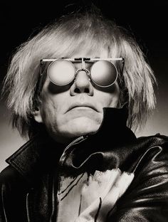 an old man wearing sunglasses and a leather jacket