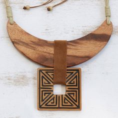 Hand-carved from muiracatiara wood an elaborate crescent forms the pendant of this statement necklace from Brazil. Cida Matos creates this majestic necklace complete with a geometric ceramic pendant that dangles below on a suede strip. Buriti palm cord circles the neck and a sliding polyester knot gives this accessory an adjustable length. Ancient Royalty, African Inspired Jewelry, Wood And Ceramic, Fiber Necklace, Travel Necklace, Found Art, Buy Wood, Ceramic Pendant, Premium Gift