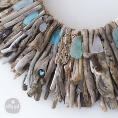 Make a splash with a magnificent 24 or 30" Salty Girl wreath! This wreath is sure to call attention to your coastal-style home when you place this work-of-art as the focal point of your carefully designed living room. You will be the envy of your friends and family! Shades of aqua and white sea glass and hand-selected small driftwood accent pieces harmonize this stunning nautical wreath with natural tones and coastal character. DETAILS: Dimensions: 24” x 2+" 30” x 2+" Ready to Hang: Wire Loop Ha Sea Glass Crafts Jewellery, Driftwood Sticks, Designed Living Room, Beach Wreaths, Rope Wreath, Beach Christmas Decorations, Driftwood Wreath, Beach Craft, Shades Of Aqua