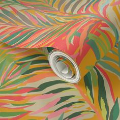 an image of a colorful wallpaper with palm leaves on the background and a roll of tape