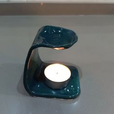 a candle holder with a lit candle in it