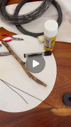 some tools are sitting on a table with wires and other items to make it look like they're making something out of wood