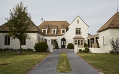 a large white house with two towers on top of it's roof and windows