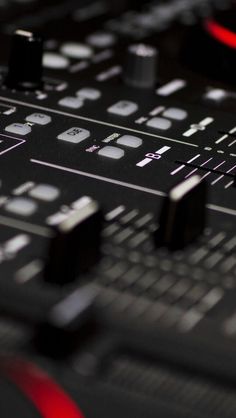 an electronic mixing board with buttons and knobs on it's side, close up