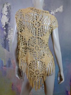 This 1970s European vintage beige lace design crochet vest has an open front that is long enough in the front to allow you to tie it closed if you like. The vest features 4-inch (10.16cm) hemline fringe. Bust = 40 inches (101.6cm) Vest Length (front) = 30 inches (76.2cm) Vest Length (back) = 33 inches (83.82cm) Size: 12 US, 16 UK Material: Wool, Acrylic Condition: Excellent (clean, soft, and supple, with no stains, tears, wear spots, or weaknesses in the seams) --- DESCRIPTION ASSURANCE --- I wa Beige Bohemian Vest Top, Vintage Beige Crochet Tops, Brown Bohemian Fringe Vest, 1970 Crochet Vest, Vintage Beige Crochet Lace Top, Uk Photos, Crochet Vest, Plaid Blazer, European Vintage