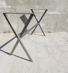 a metal table sitting on top of a cement floor