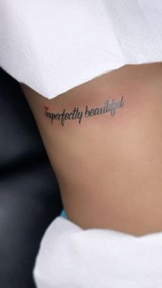 a woman's stomach with the words imperfectedly beautiful written in cursive ink