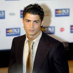a man in a suit and tie posing for the camera