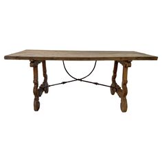 an old wooden table with two legs and a rope on the top, against a white background