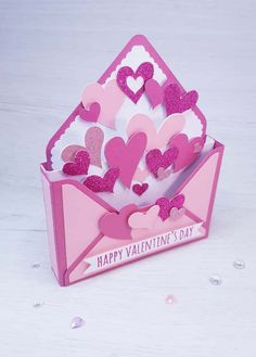 a valentine's day card with hearts in an envelope