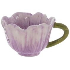 a purple flower shaped bowl sitting on top of a white table next to a green handle