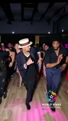 two men dancing on the dance floor at a party