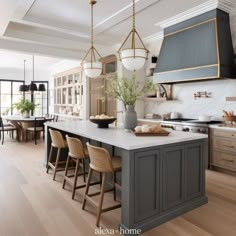 a large kitchen with an island in the middle and chairs around it, along with other furniture