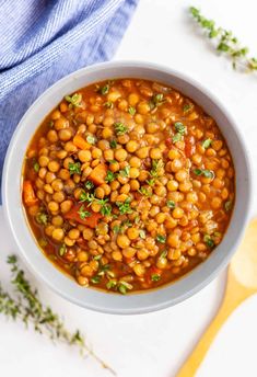 a white bowl filled with beans and parsley