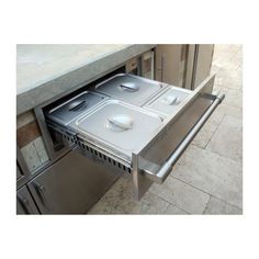 two pans are placed in the bottom drawer of a stainless steel dishwasher