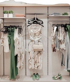 an organized closet with clothes and shoes