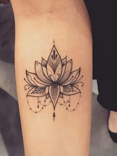 a black and white lotus tattoo on the leg