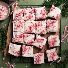 peppermint marshmallow fudges on a cooling rack with candy canes