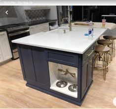 a kitchen with an island and sink in it