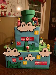 a three tiered cake made to look like mario's house