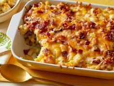 a casserole dish filled with macaroni and cheese on a yellow place mat