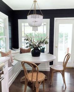 an instagram photo of a dining room table with chairs and a chandelier