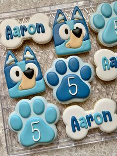 decorated cookies in the shape of paw prints with name and number