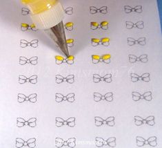 a paper with glasses drawn on it next to a marker and some yellow rubber pens